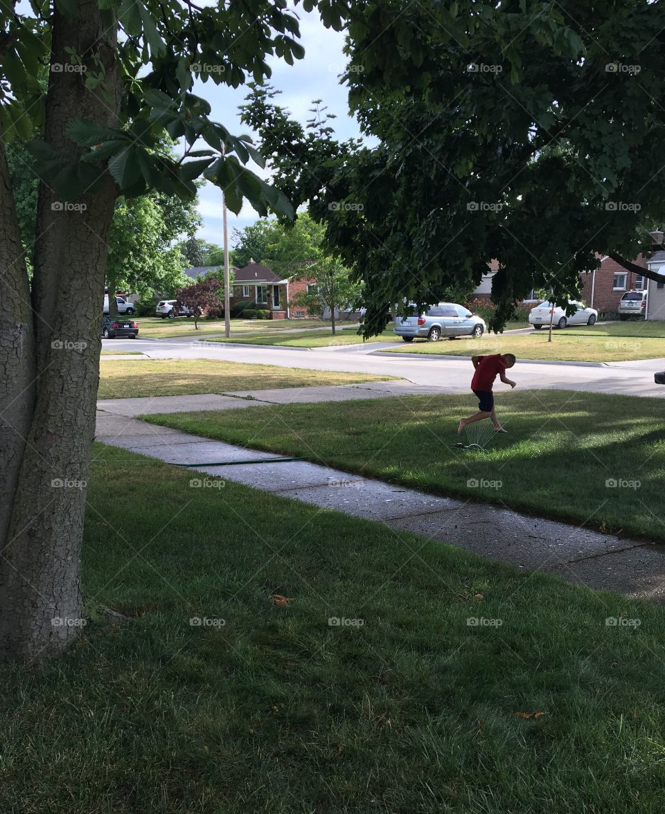 Playing in the sprinkler. 