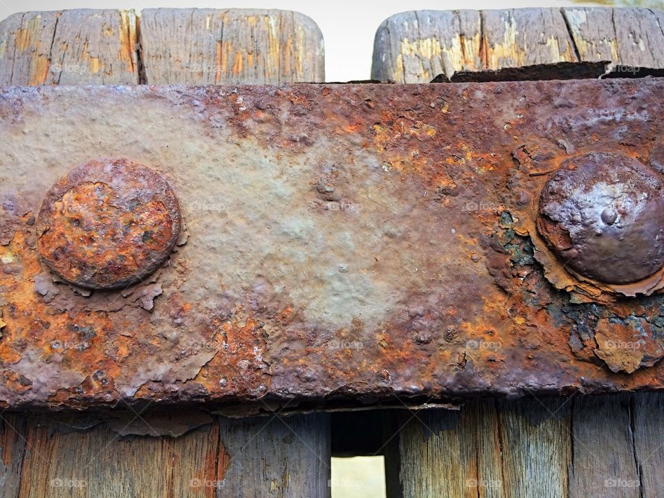 Rusty iron texture in wood bench