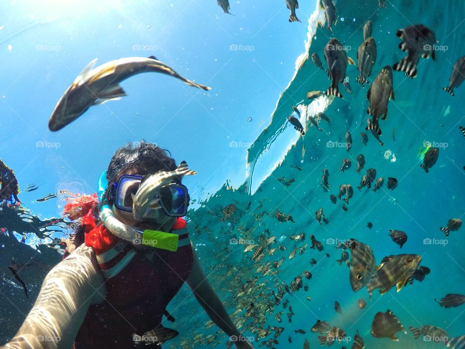 Close-up of scuba diver with fish