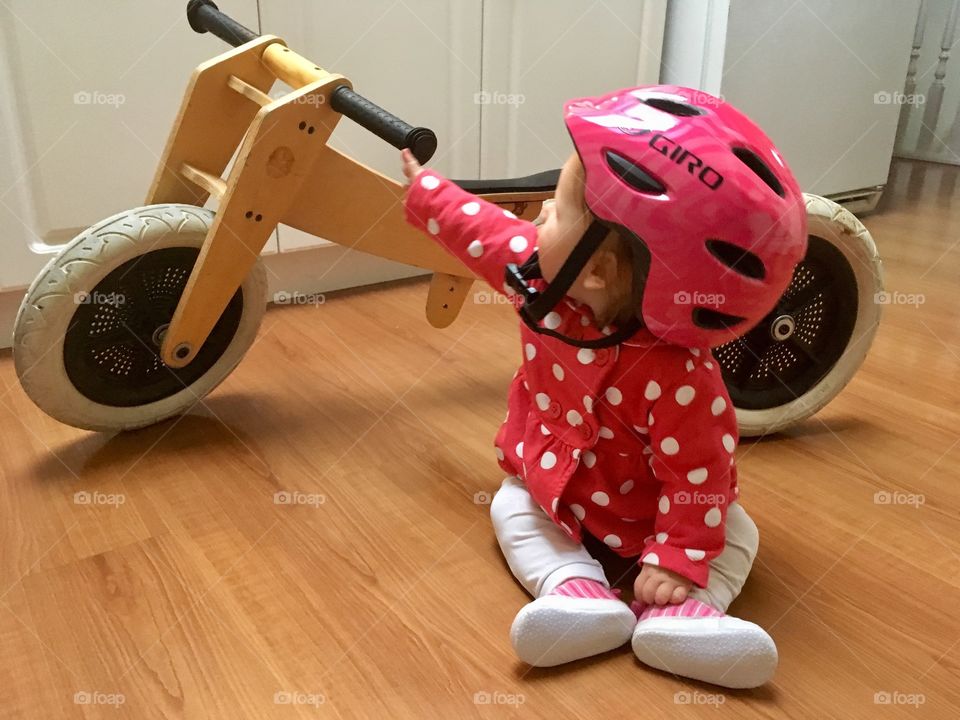 Baby with helmet and bike