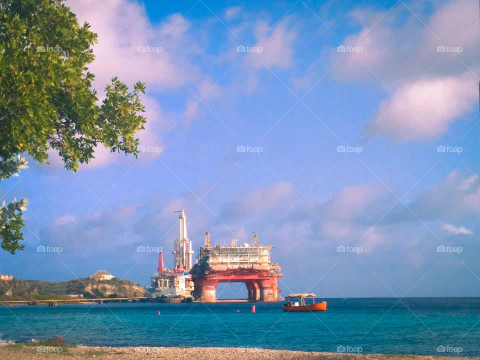 Nice view of the orange boat and 2 tankers out at sea with that beautiful blue sky 🏝⛵☁
