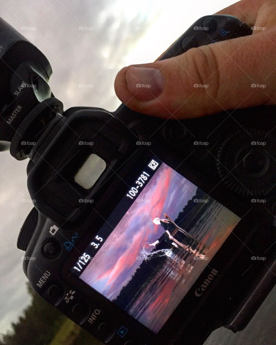 Photographer showing the back of his camera 