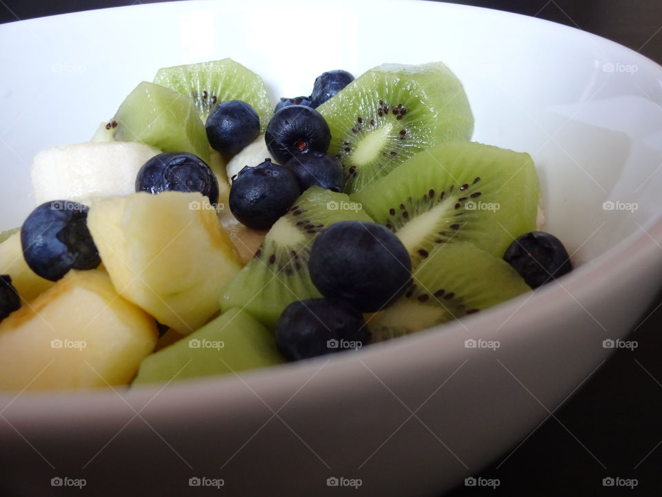 Healthy fruits breakfast full of vitamins with kiwi, banana ,apple and berries