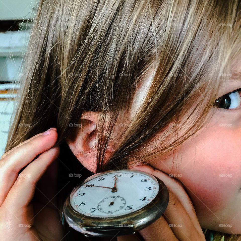 I'm hearing  the time. Little girl hearing the clock ticking for the first time wondering what the sound is