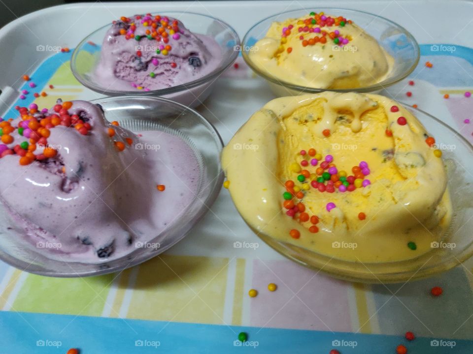 homemade ice creams on a colorful tray topped with colorful sprinkler