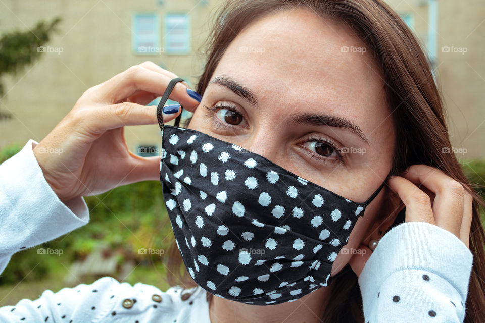 Beautiful woman smiling with her eyes behind the face mask