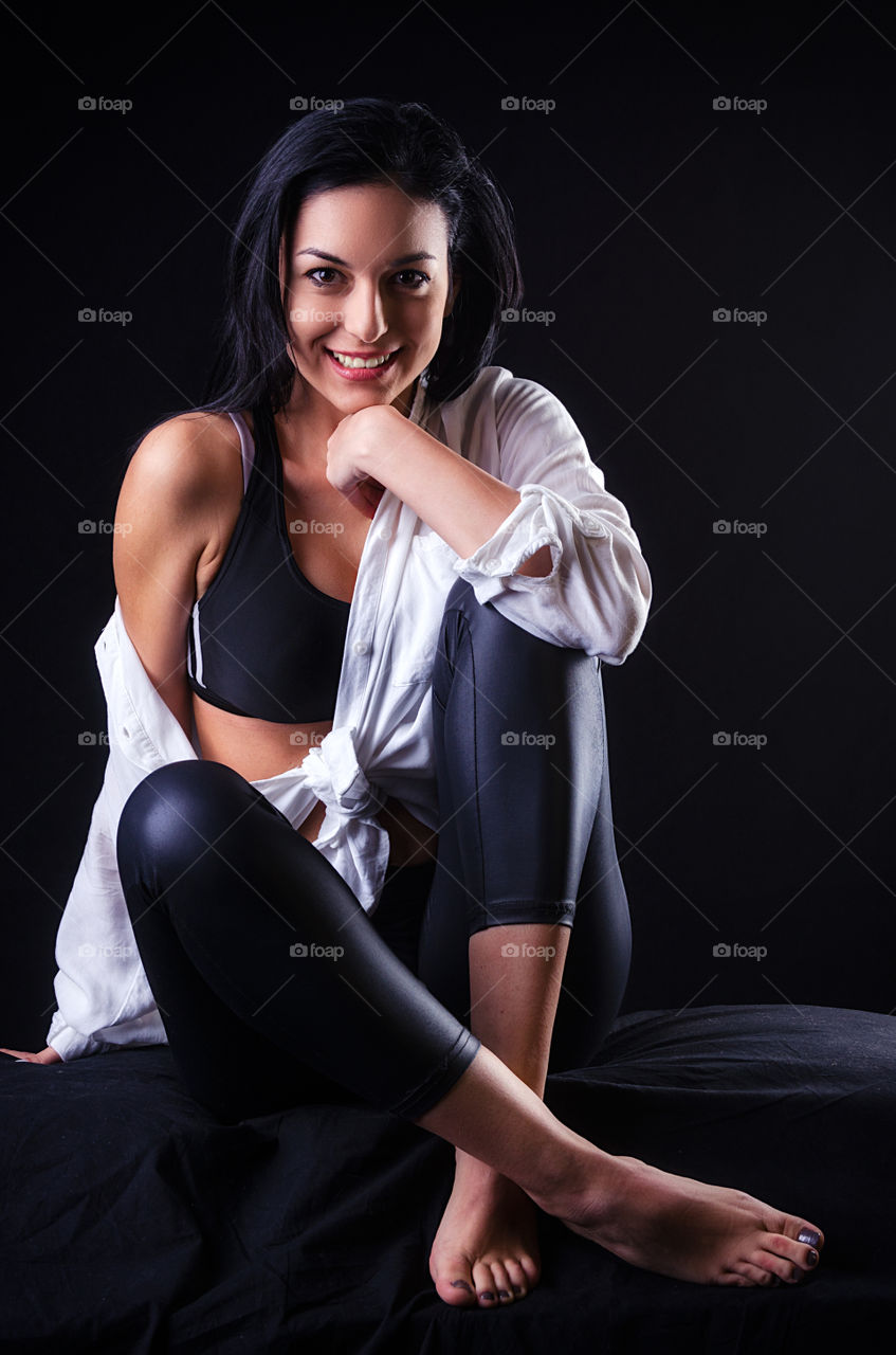 Happy sport woman on black background