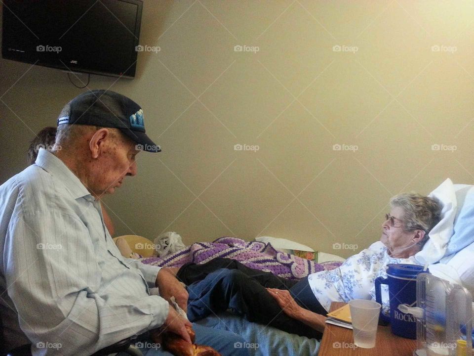 Senior woman on hospital bed with her husband