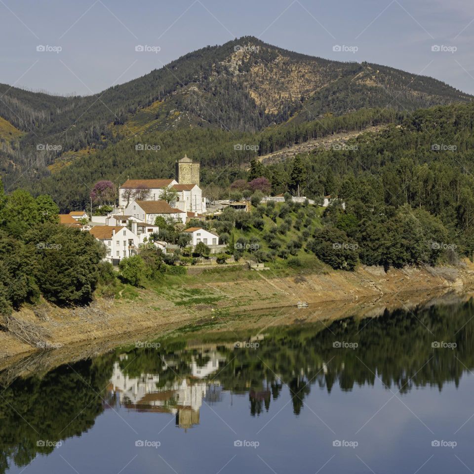 A view of the village Nossa Senhora do Pranto, reflected in Rio Zêzere. Dornes, Portugal April 2022