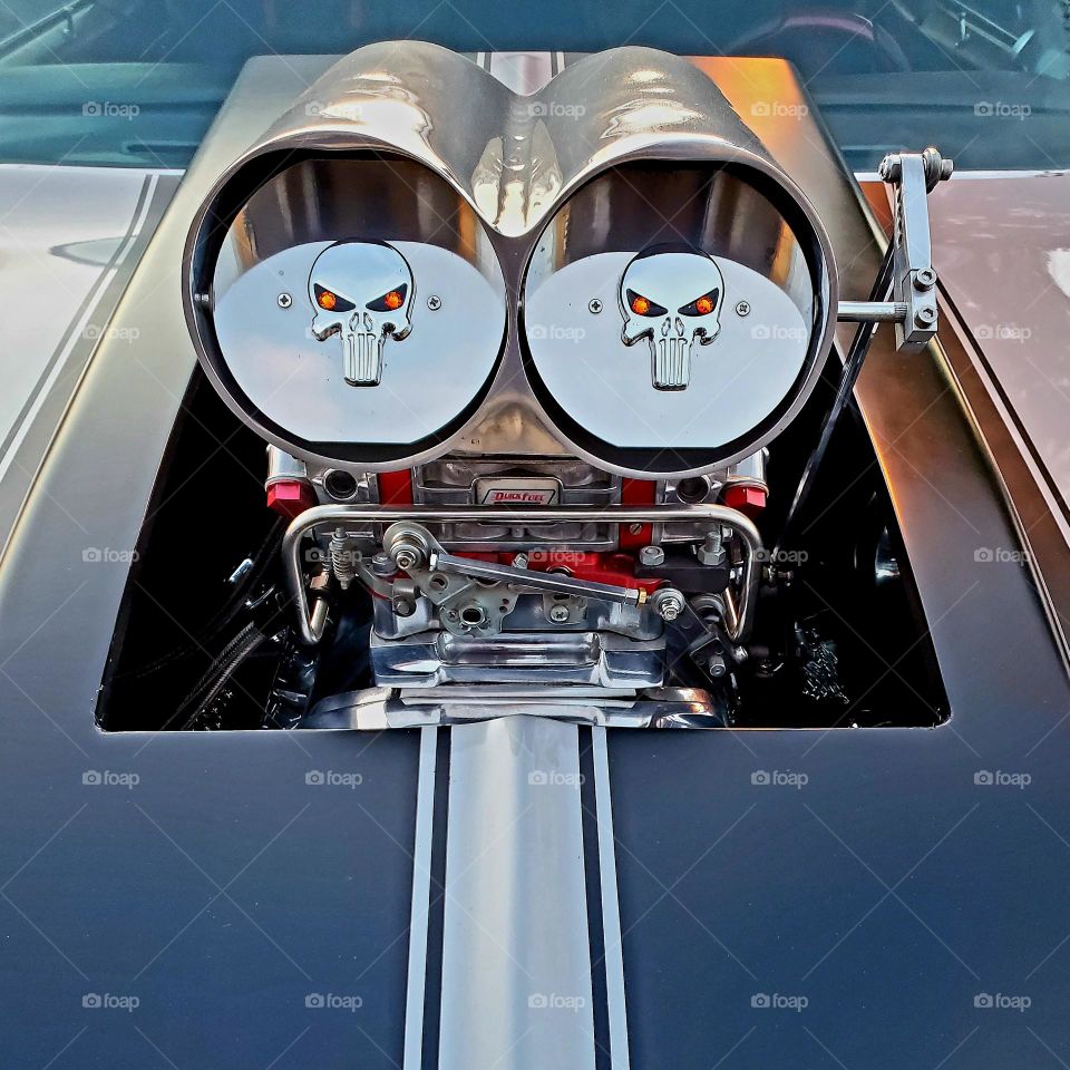 Dual air intakes on a hot rod stick out above the hood and feature the skeletal logo of The Punisher