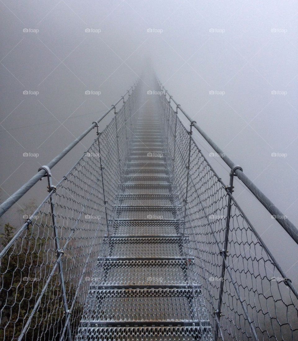 Tibetan bridge surrounded by mist