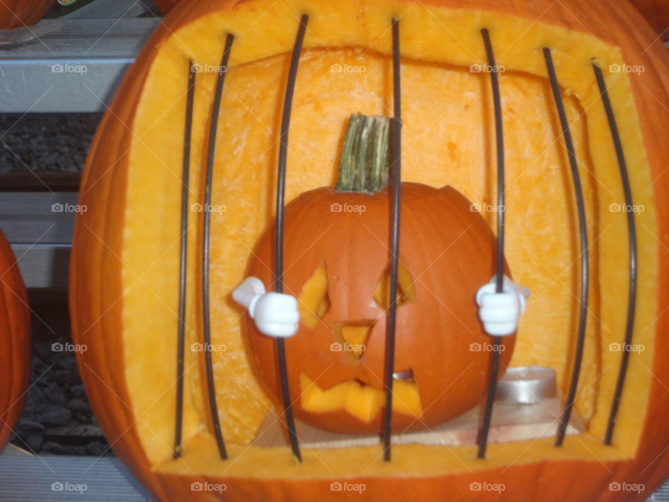 A jack-o’-lantern trapped inside a pumpkin