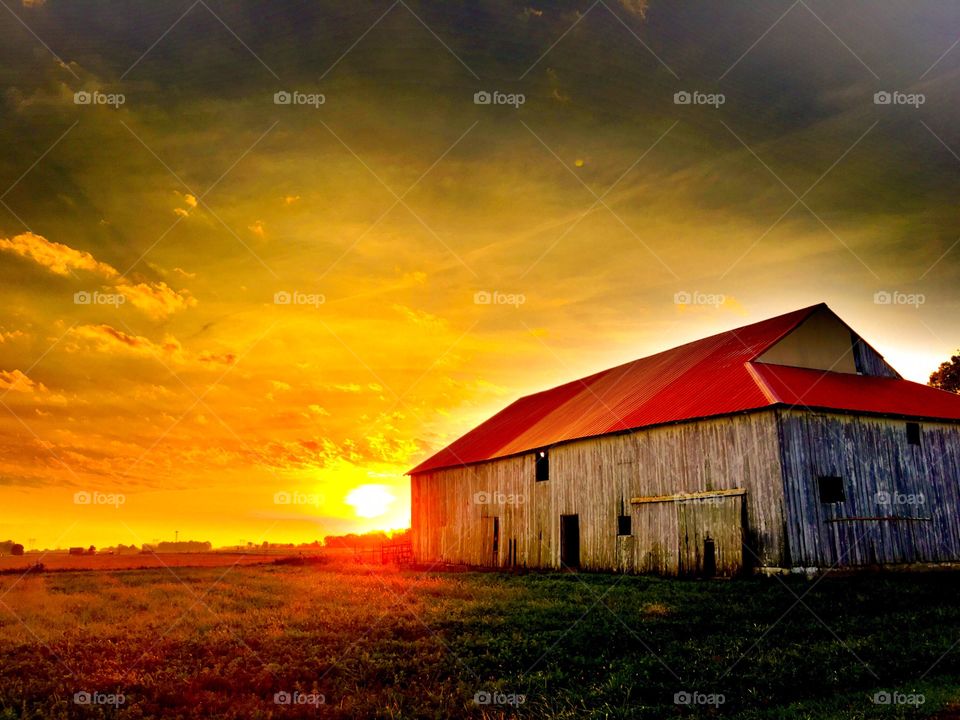 Beautiful sunrise  with the old barn 