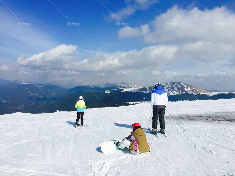 Group of people skiing and snowboarding on the slope