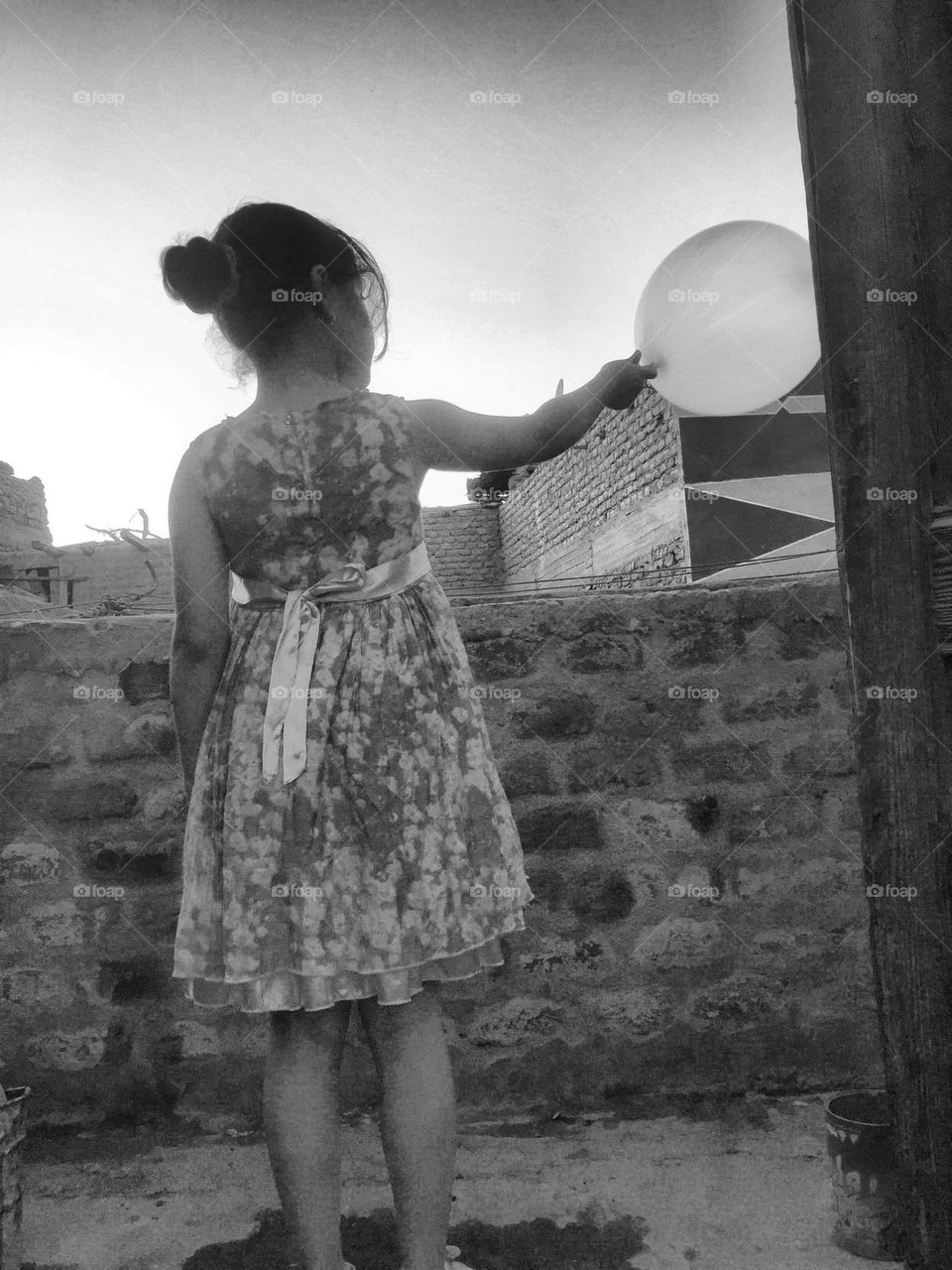 A girl is playing with balloon