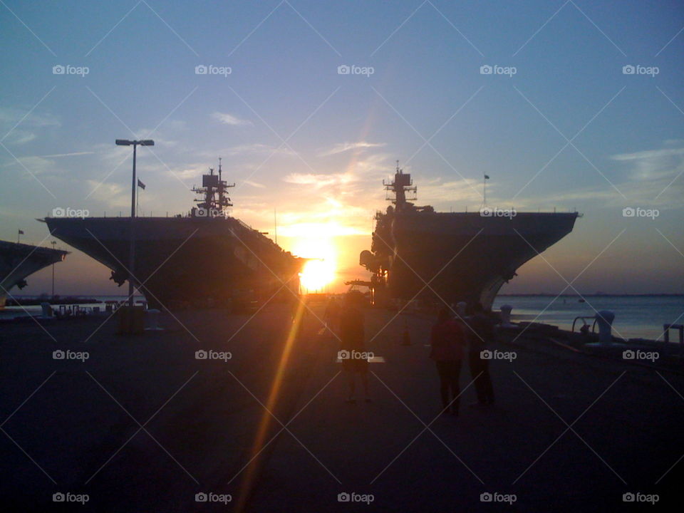Sunset between LHDs. Sunset between two Landing Helicopter Dock ships at Norfolk Naval Base in Norfolk, VA