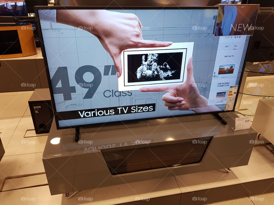 Samsung 49" The Frame art mode television on grey TV stand at Peter Jones department store Sloane square Chelsea Kings road London