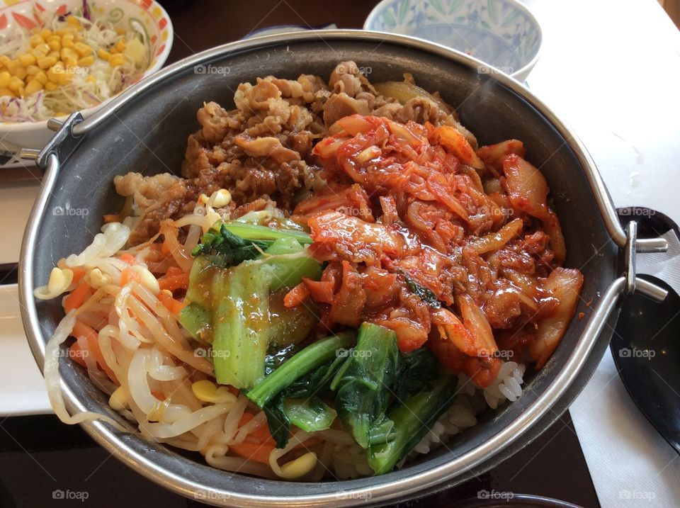 Kimchi, bean sprout, beef bowl with rice, a raw egg and some good salad. Healthy and delicious!