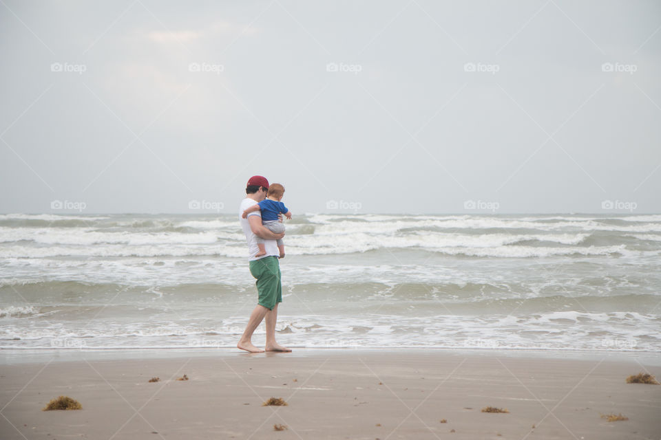 Father and baby at beach