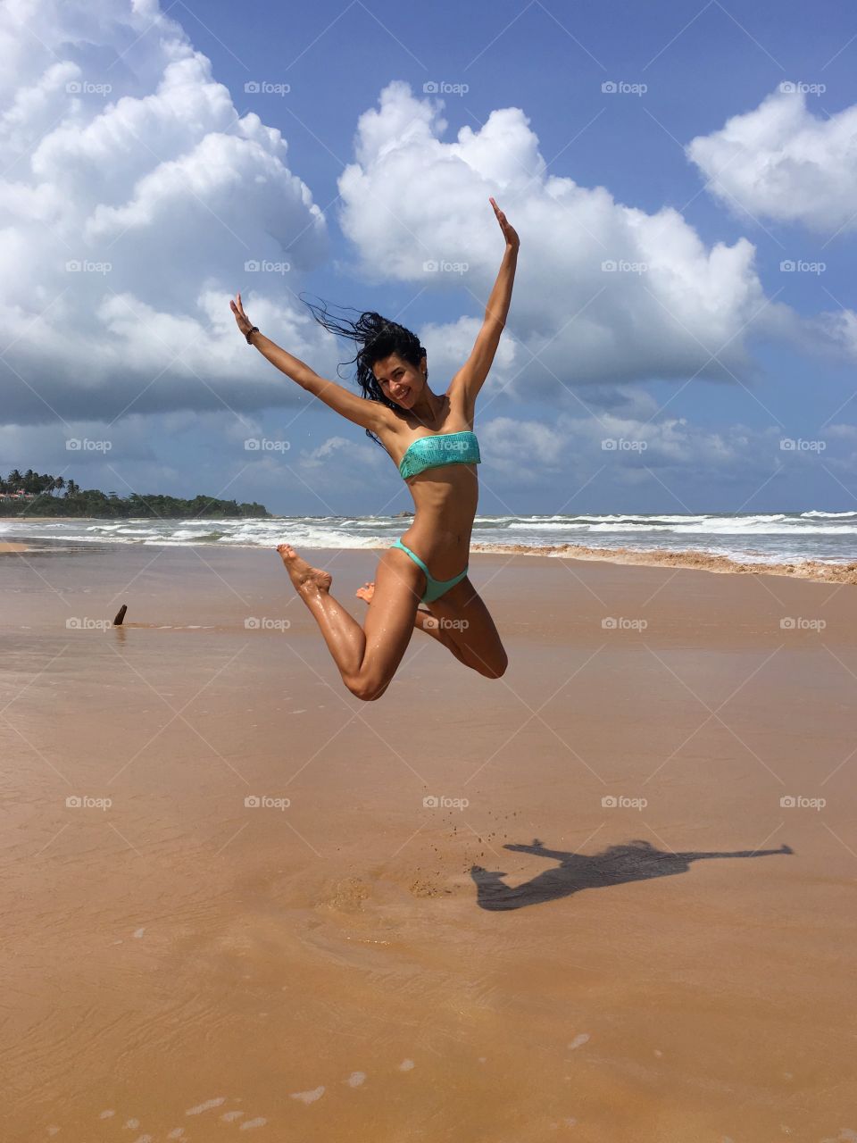 Woman jumps on the beach