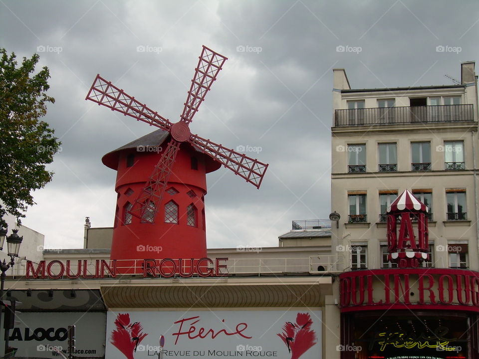 The Moulin Rouge against a cloudy sky 