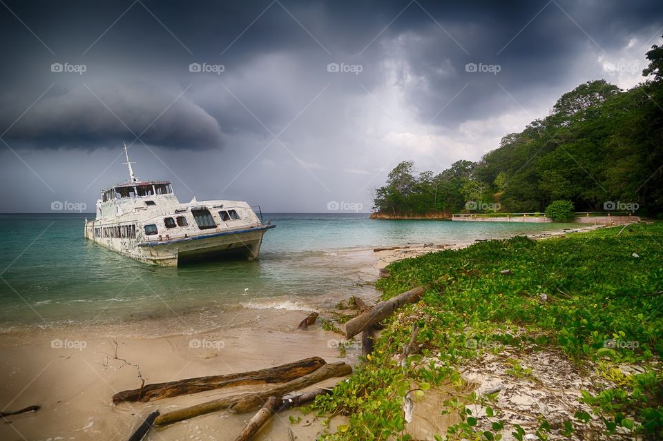 Stranded boat with storm clouds