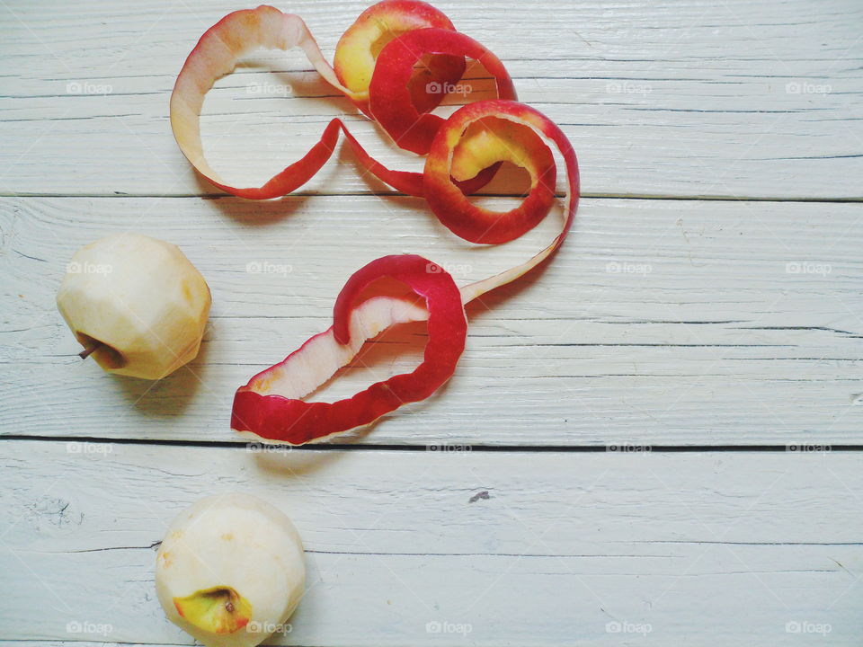 Two peeled apples from the peel