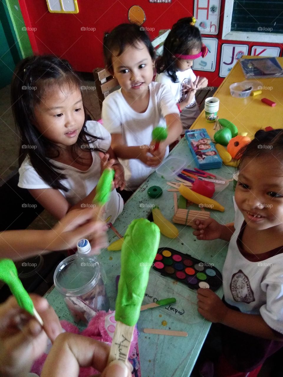Children making popsicle with clay