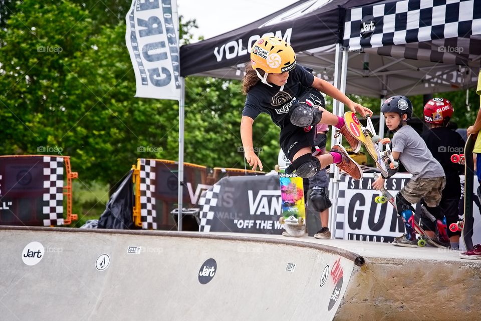 A boy makes a jump with his skateboard