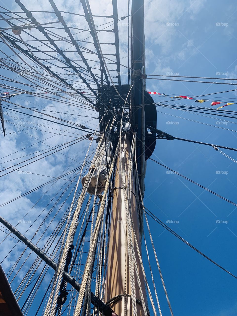 Brig Niagara, Tall Ships. With 6 miles of rope and 188 Tons of sail power this ship stands tall with pride & history. Helping to win the war of 1812, this shot accentuates the knowledge needed to sail. Beautiful Erie skies contrast the miles of rope.