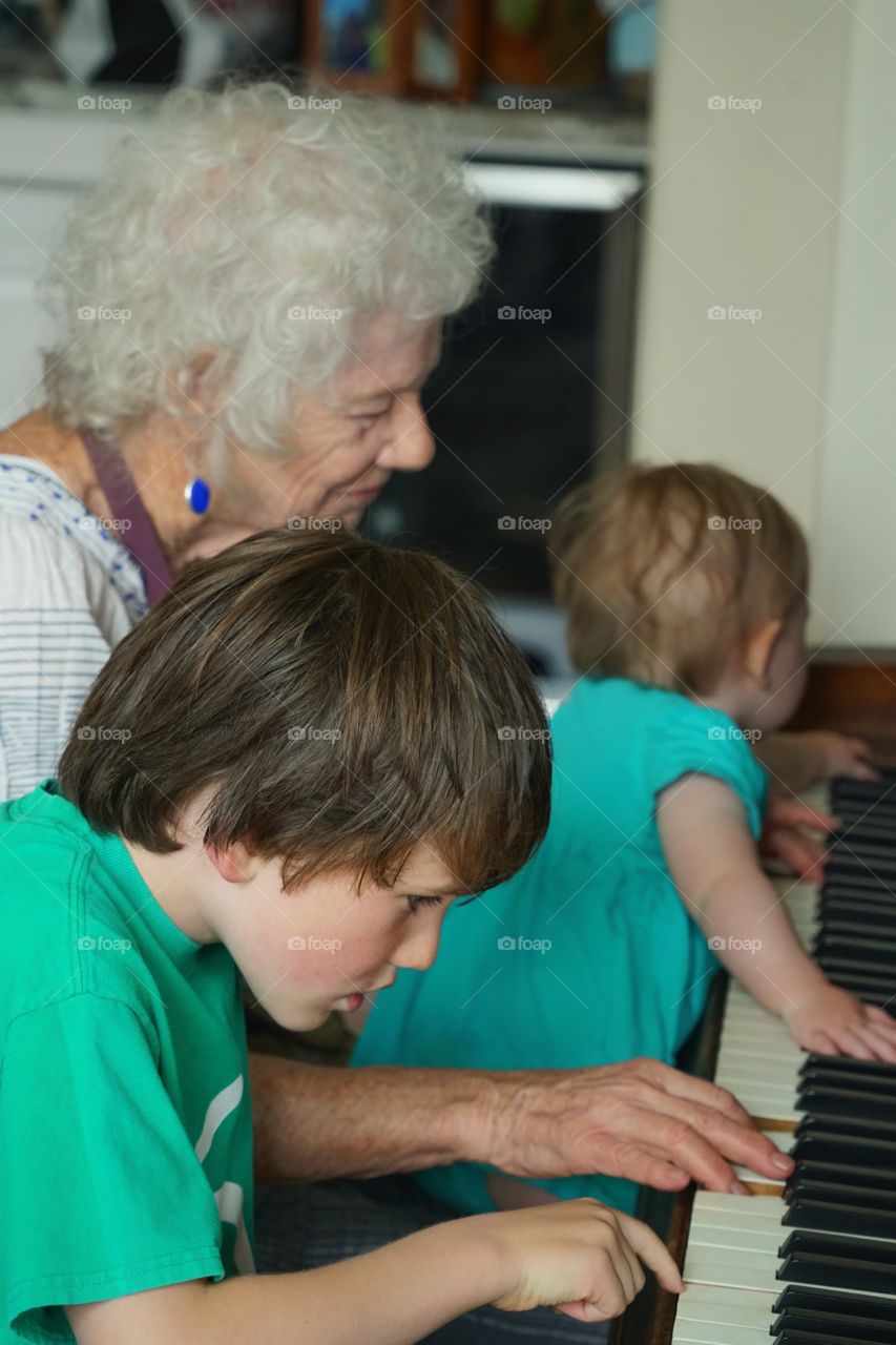 Grandmother Playing Piano With Grandchildren