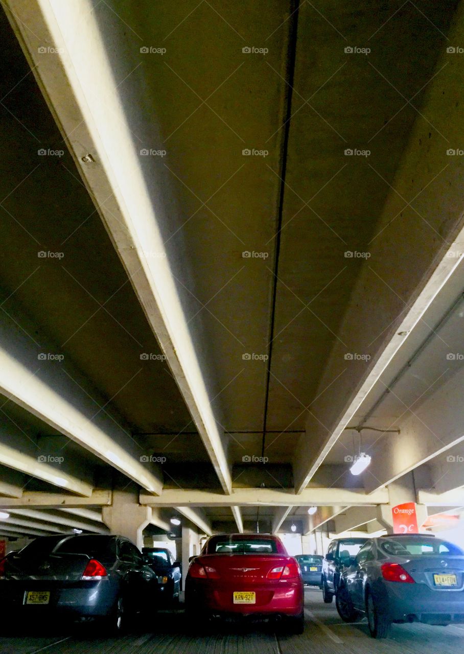 Three parked cars in a parking garage 