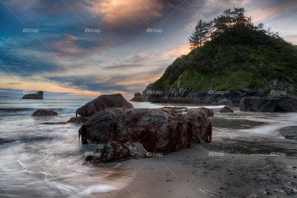 Surf at beach at the time of sunset