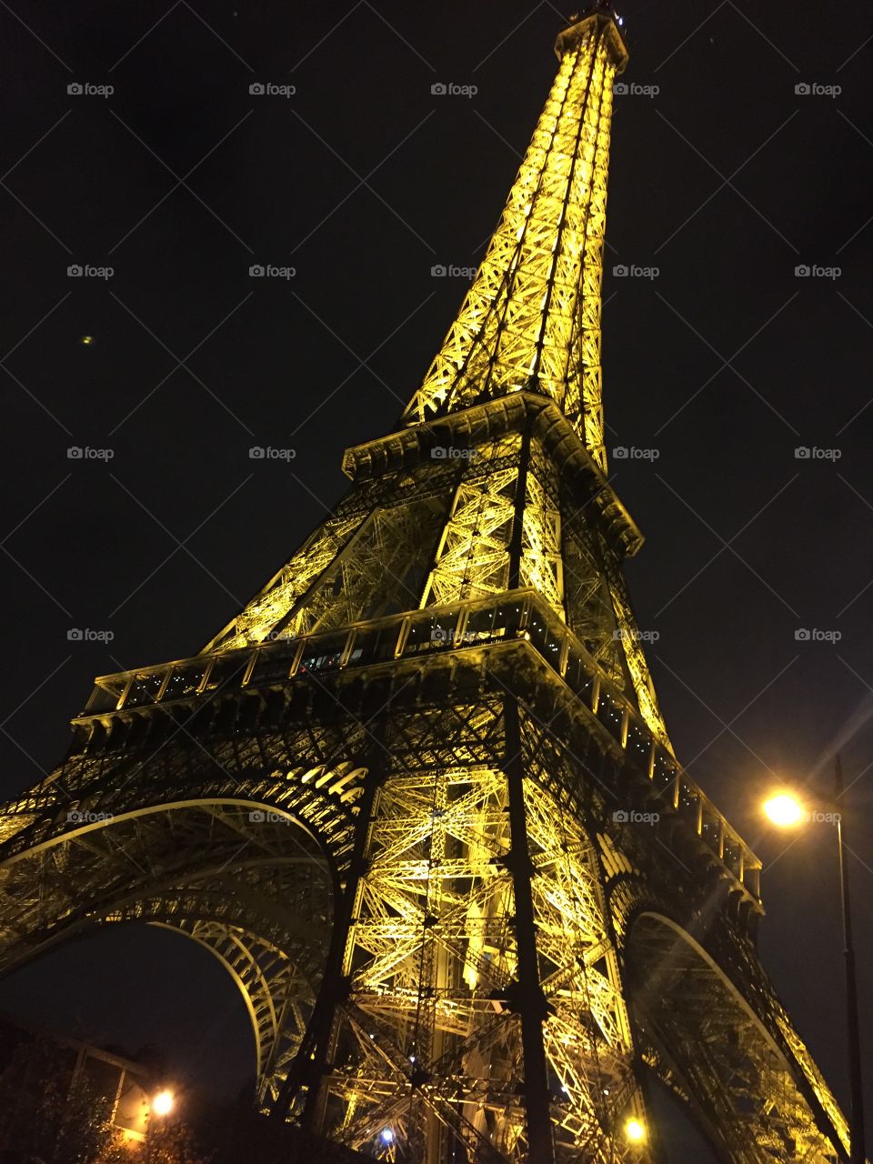 Eiffel Tower to the top in the night. 
