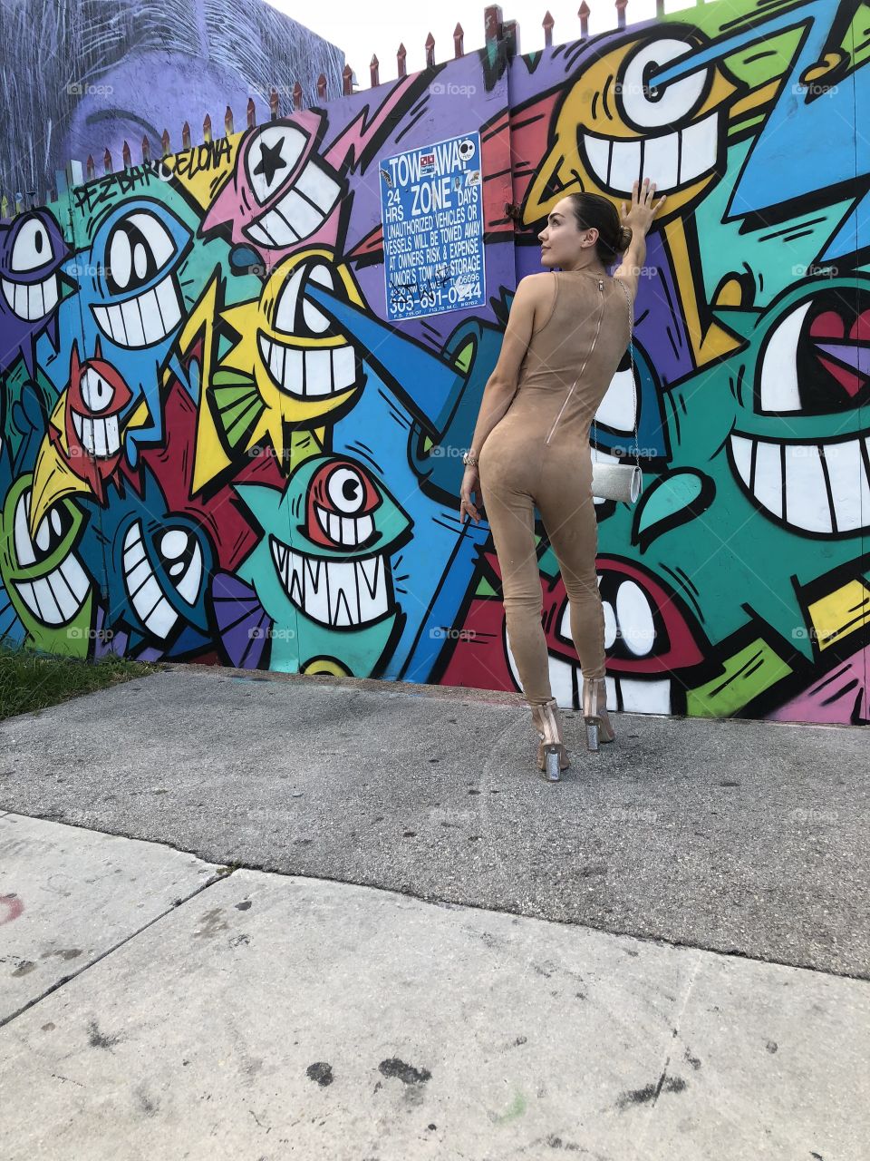 Model looking pretty next to street art