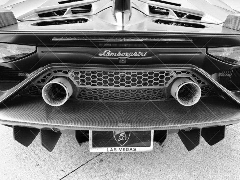 The rear end of the Lamborghini Aventador in black and white