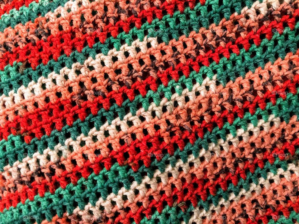 Close up of colorful handmade crocheted item surface