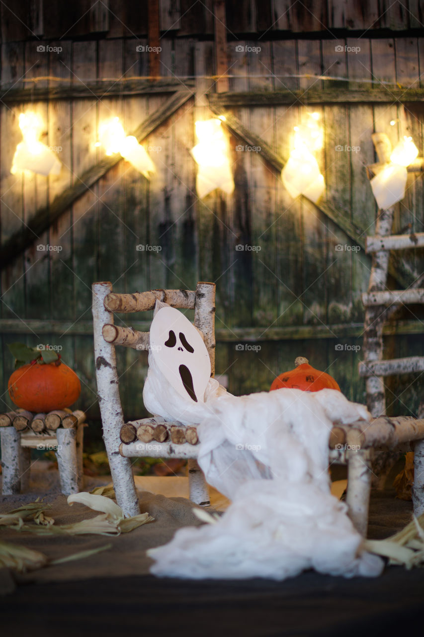 Ghost mask on a wooden bed.