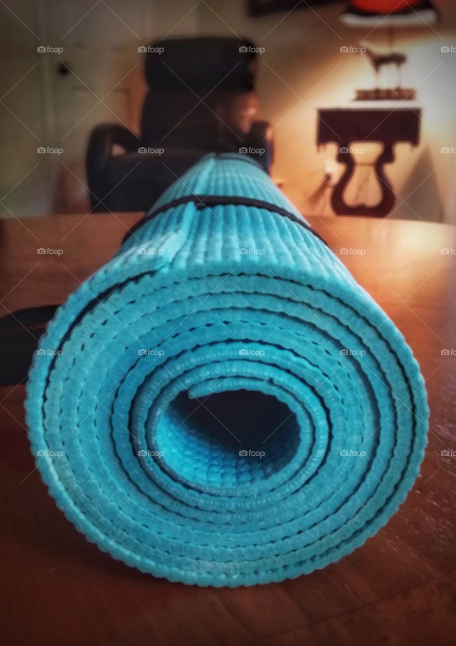 Yoga mat on a table in front of an easy chair. It's time to get up and move, meditate or stretch :)
