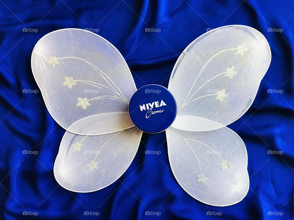 Nivea cream with white butterfly and blue background.