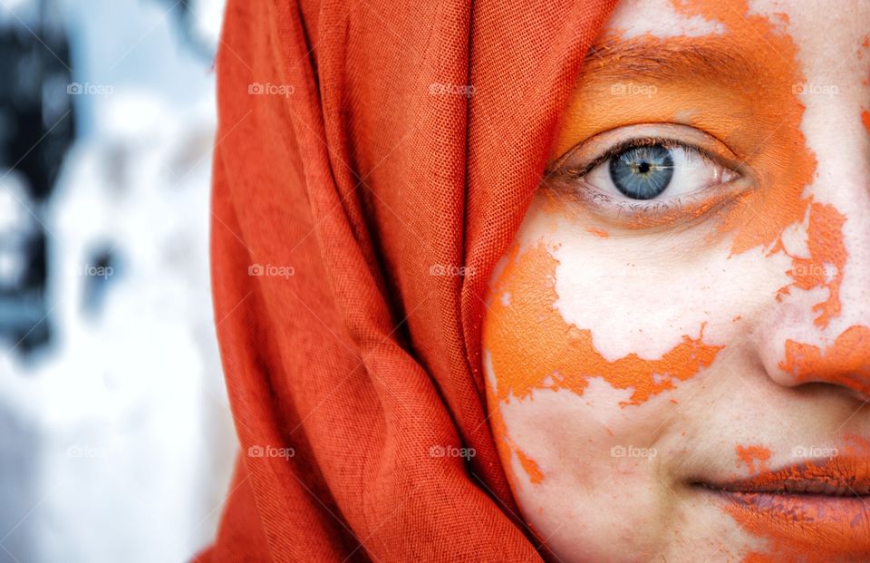the girl with blue eye and orange scarf