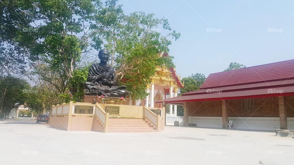 Antique Somdet toh statue , Great famous old monk of thailand , thai people respect and believe in him , tree and church temple background ; April 10 ,2018 in ratchaburie thailand