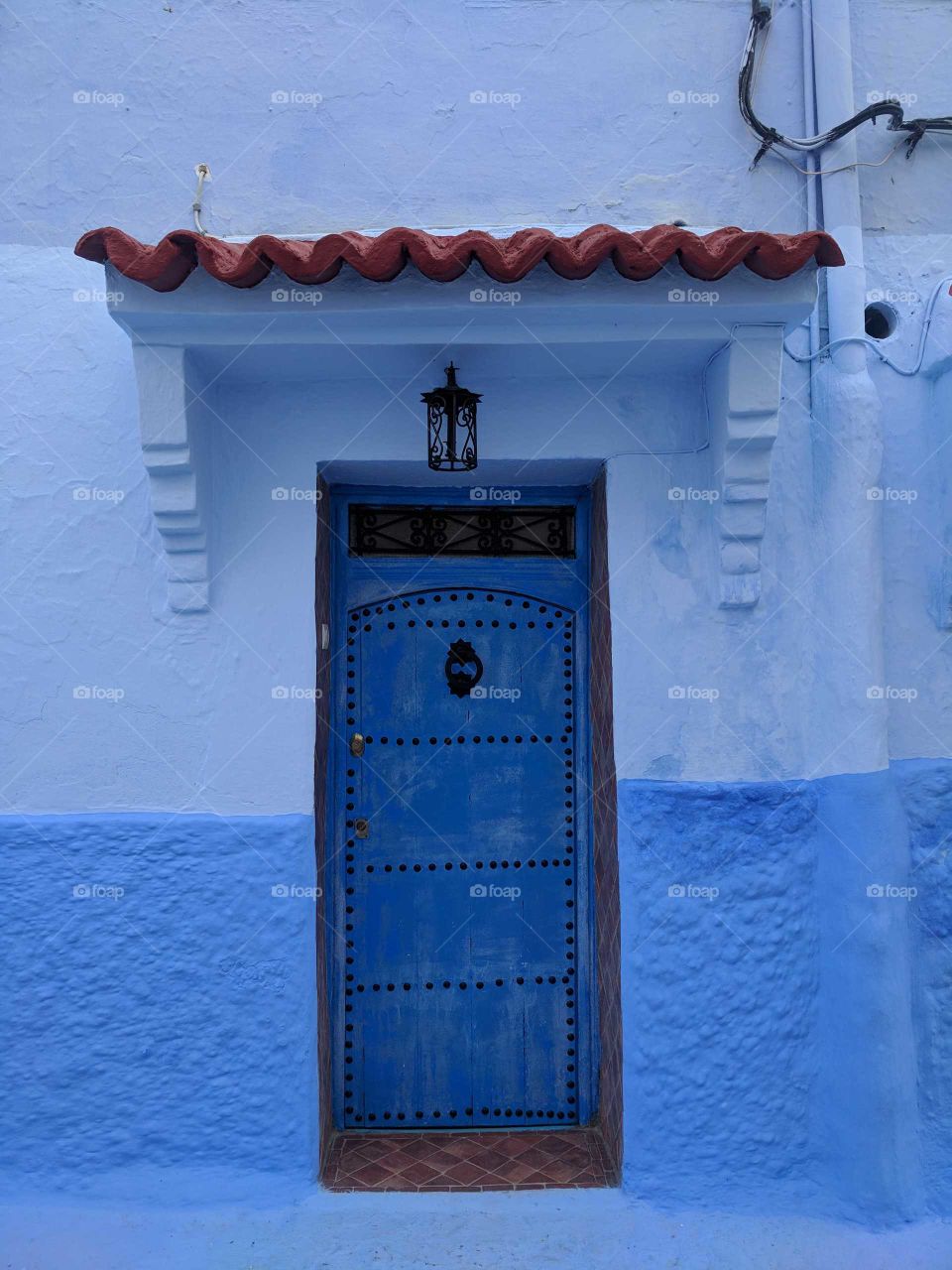 Adorable Blue Doorway with Big Blue Stripe Wall in Chefchaouen (the Blue City) in Morocco