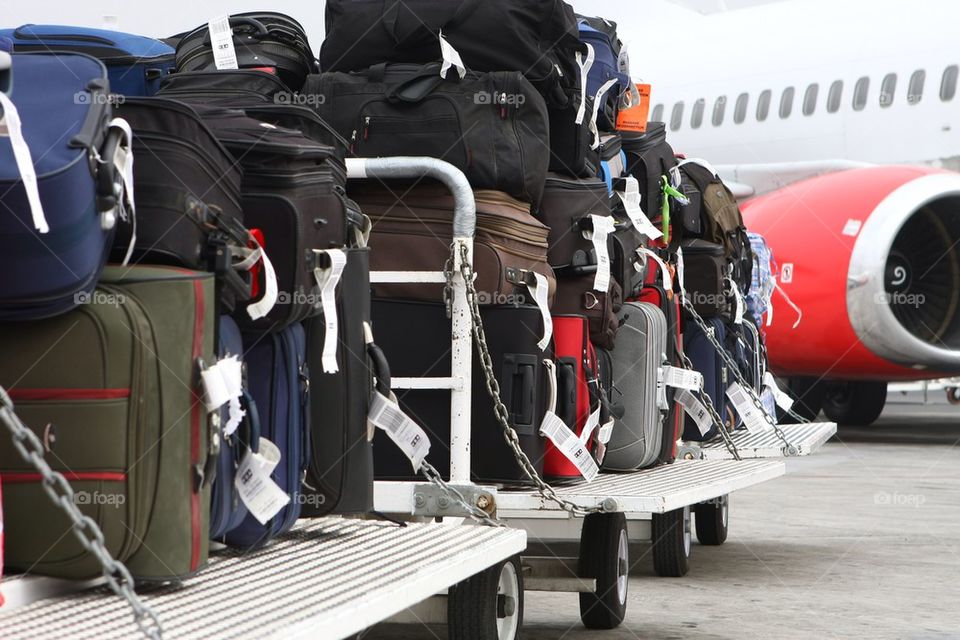 Load of luggage bags about to be shipped in a jet plane. Vacation