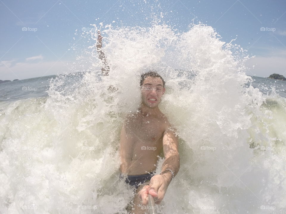 Man taking selfie in ocean