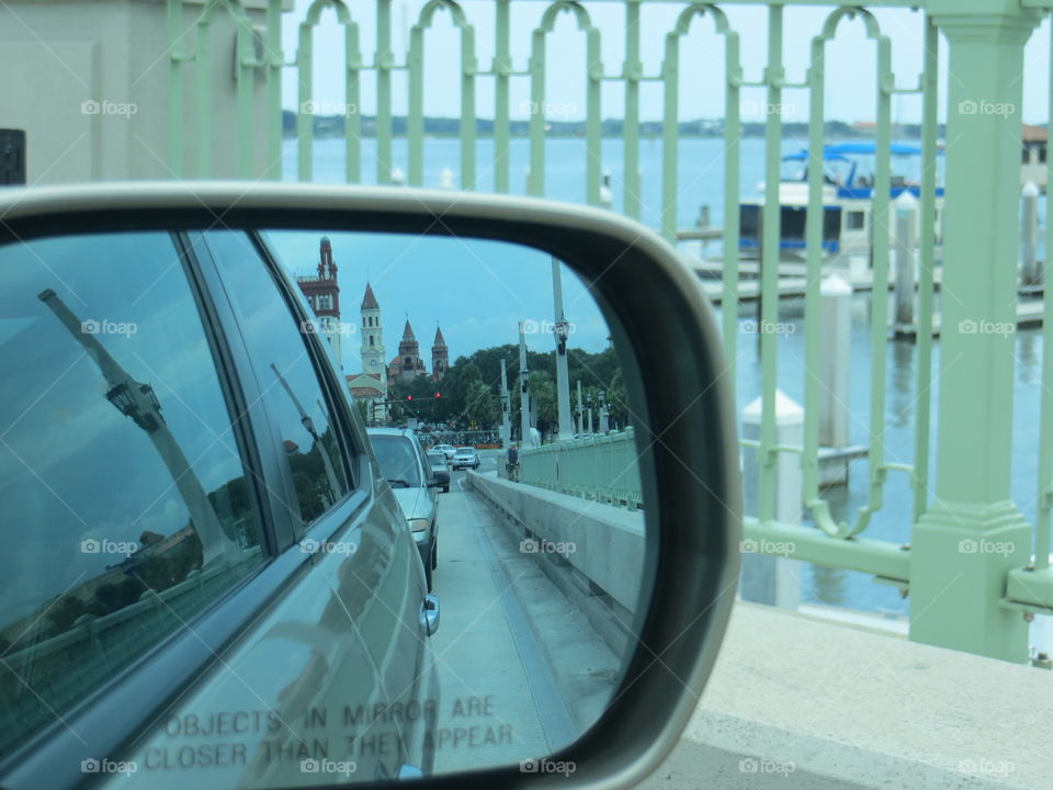Two views of historic St. Augustine - water with boats & old buildings in rear view mirror