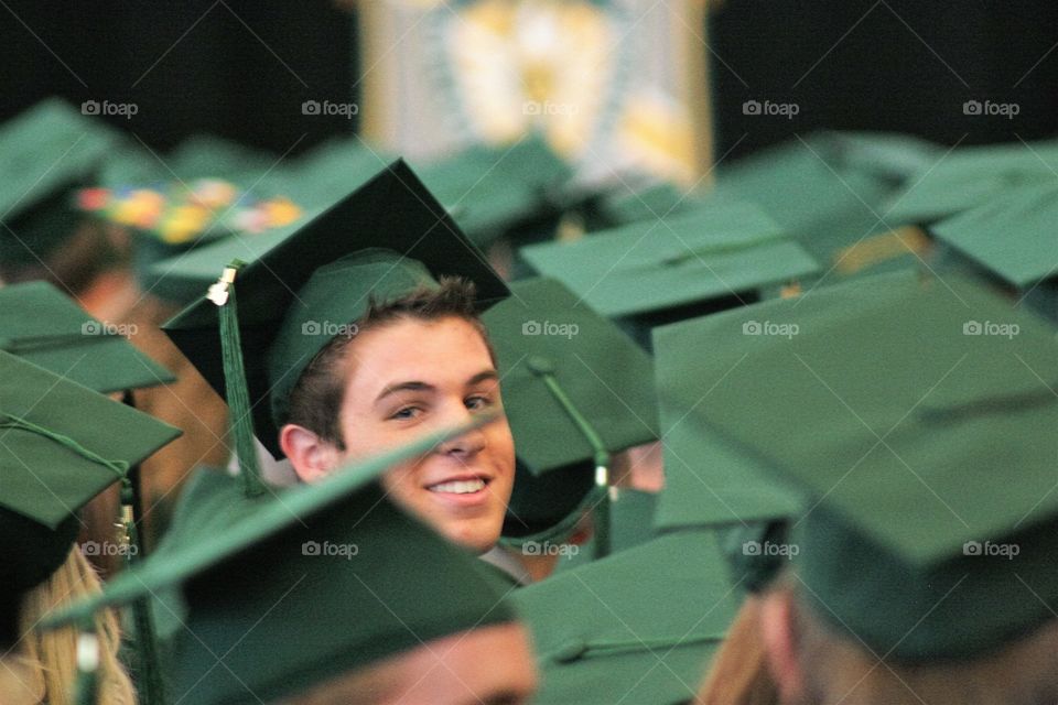 Teenage boy wearing graduation hat