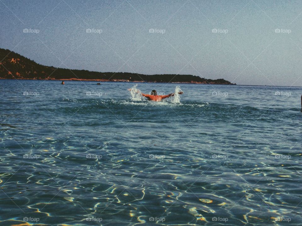 Swimming in the ocean on the summer holiday. Vacation time with family and friends.
