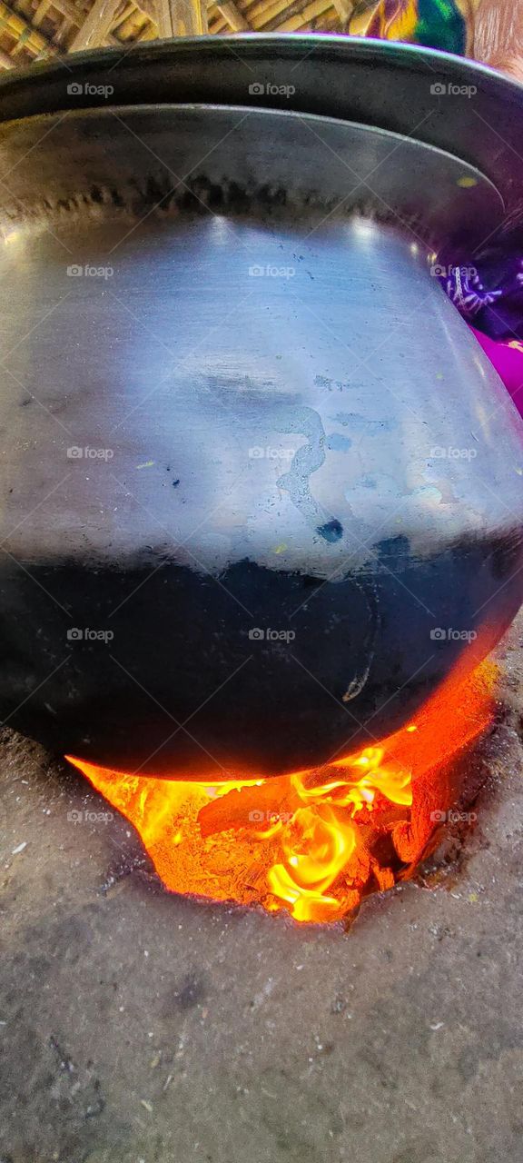 cooking rice in large bowl at Village.