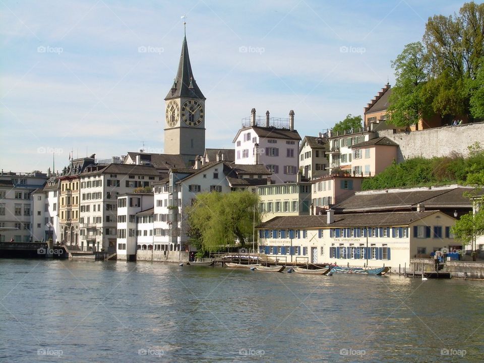 water clock tower boats river